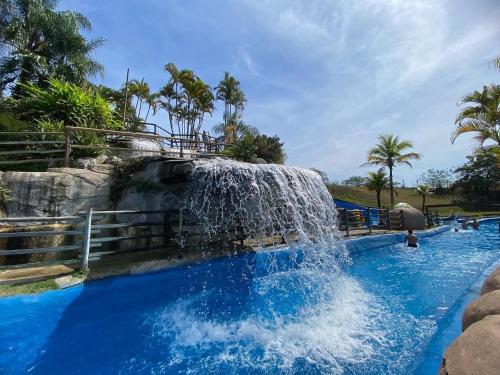a waterfall in a pool at a water park at Aldeia das Aguas Village in Barra do Piraí