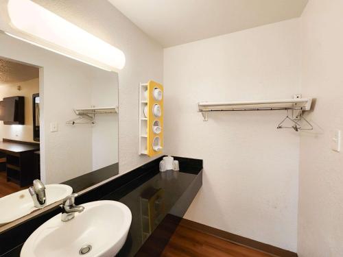 a bathroom with a white sink and a mirror at Motel 6-Baytown, TX - Baytown East in Baytown