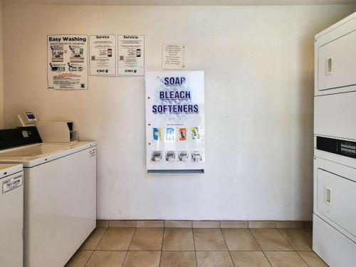 a kitchen with a white wall with signs on it at Motel 6-Baytown, TX - Baytown East in Baytown