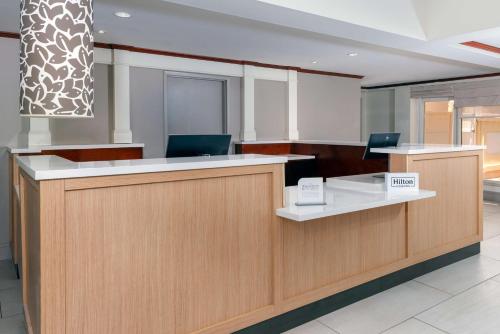 an office with a reception desk with two chairs at Hilton Garden Inn Ft. Lauderdale SW/Miramar in Miramar