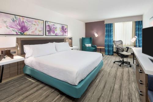 a hotel room with a bed and a desk at Hilton Garden Inn Lafayette/Cajundome in Lafayette