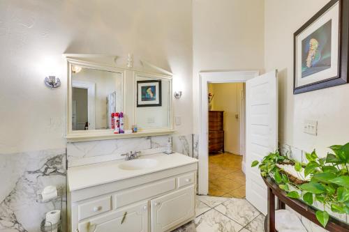 a white bathroom with a sink and a mirror at Central Albany Home with Covered Porch and Patio! in Albany