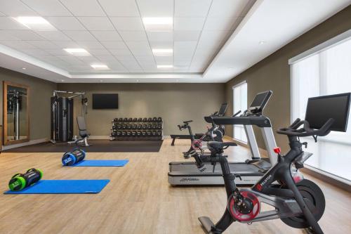 a gym with several exercise bikes and a flat screen tv at Hampton Inn Stockton, Ca in Stockton