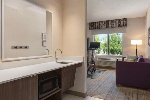 a bathroom with a sink and a living room at Hampton Inn Stockton, Ca in Stockton
