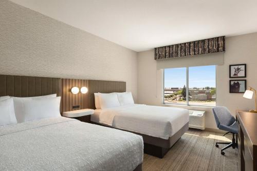 a hotel room with two beds and a window at Hampton Inn Stockton, Ca in Stockton