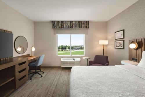 a hotel room with a bed and a desk and a window at Hampton Inn Stockton, Ca in Stockton