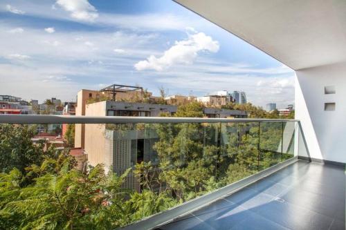 a balcony with a view of a city at Corazón de Condesa 3 departamentos - 200Mbps WiFi, Roof, Gym in Mexico City