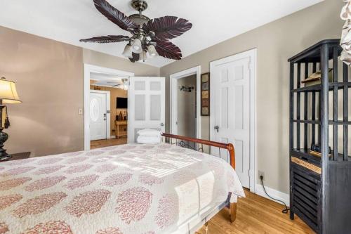 a bedroom with a bed and a ceiling fan at Dazzling Centrally Located Ocean View w 2 Kings, Huge Private Yard, 2 Decks, Firepit, BBQ in Myrtle Beach