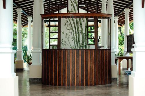 a wooden exhibit in a building with a plant at Riverside Cabanas in Mirissa