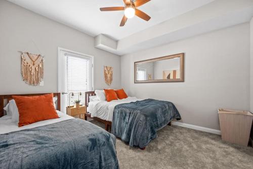 a bedroom with two beds and a ceiling fan at City View BOHO Apt Stocked w everything you need in Salt Lake City