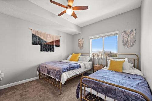 a bedroom with two beds and a ceiling fan at Charming Downtown Getaway in Salt Lake City