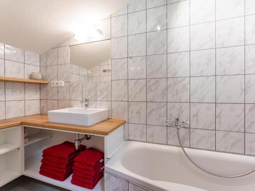 a bathroom with a sink and a bath tub at Haus Juen II in See