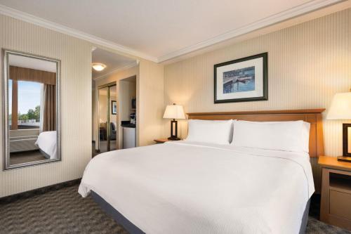 a large white bed in a hotel room at Holiday Inn & Suites North Vancouver by IHG in North Vancouver