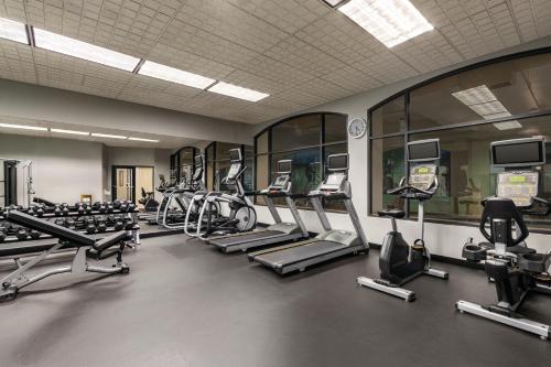 a gym with a row of treadmills and machines at Holiday Inn & Suites North Vancouver, an IHG Hotel in North Vancouver