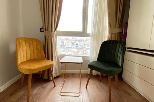 two chairs and a table in a room with a window at Toya next in Istanbul