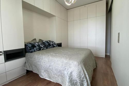 a bedroom with a bed and white cabinets at Toya next in Istanbul