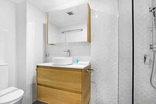 a bathroom with a sink and a toilet and a shower at Oceanside Cove in Gold Coast