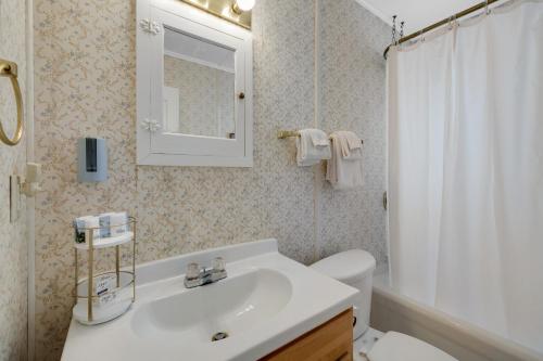 a bathroom with a sink and a toilet and a mirror at Whale Vista in Depoe Bay