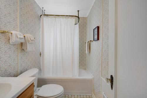 a bathroom with a white toilet and a shower at Whale Vista in Depoe Bay
