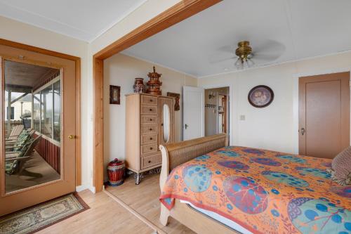 a bedroom with a bed and a clock on the wall at Whale Vista in Depoe Bay