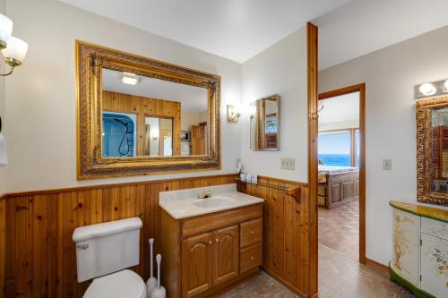 a bathroom with a sink and a mirror at Whale Vista in Depoe Bay
