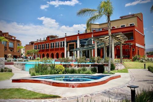 a building with a swimming pool in front of a building at "San Miguelito" El oasis urbano que necesitas para descansar! pool, gym, tenis in San Miguel de Allende