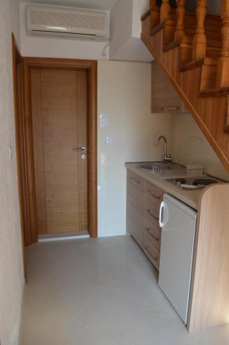 a kitchen with a sink and a stove top oven at Apartments TMV Dragovic in Sveti Stefan