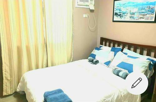 a bedroom with a bed with a robot on it at Amaia Steps Condominium Studio -across Ayala Mall Capitol Central in Bacolod