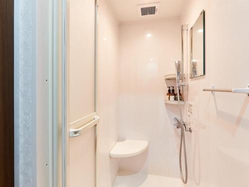a white bathroom with a toilet and a shower at Grand Cabin Hotel Naha Oroku for Men / Vacation STAY 62323 in Naha