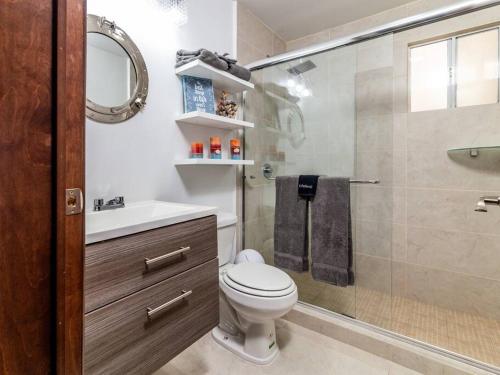 a bathroom with a shower and a toilet and a sink at Ocean View 15 Gardenhaus in Tijuana