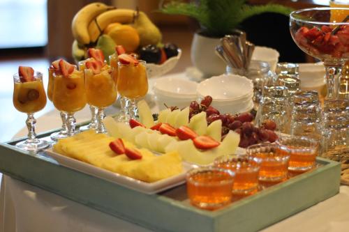a tray of food with fruit and drinks on a table at Hotel Ontiveros in San Fernando