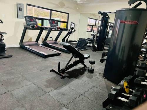 a gym with several treadmills and exercise machines at FlowerPot by the Sea in Lucea