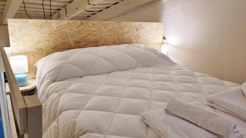 a large white bed in a room with at Interra Apart 2 in Salta