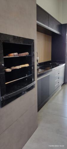 a large kitchen with a stove top oven at Residência Cidade Verde 3 in Maringá