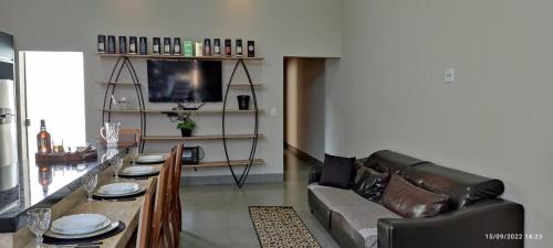a living room with a couch and a table at Residência Cidade Verde 3 in Maringá