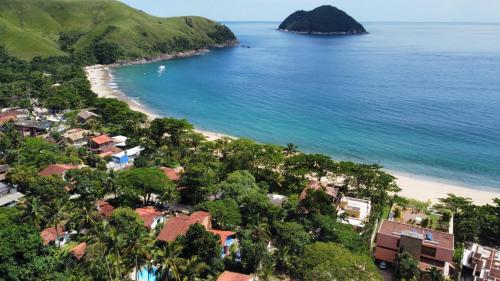 una vista aérea de una playa con casas y el océano en Vila dos Tangarás, Casa 1 Praia, a 30m do mar en Toque Toque Grande