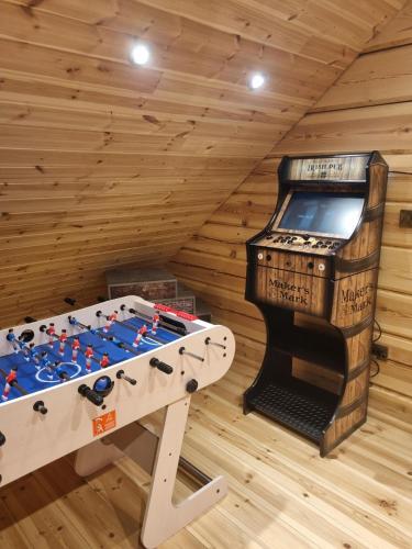 a room with a foosball table in a log cabin at Amazing 14 Berth Villa With Private Pool At Pentney Lakes In Norfolk Ref 34079A in Kings Lynn