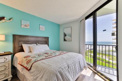 a bedroom with a bed with a view of the ocean at 1 Bedroom -1 Bath With Ocean Views At Ocean Trillium 302 in New Smyrna Beach