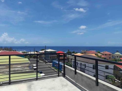 a balcony with a view of the ocean at Square One Properties Inc. in Roseau