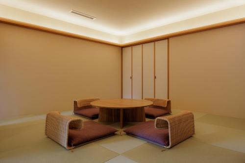 a meeting room with a table and chairs at Kifuno Sato in Mimasaka