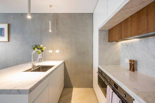 a kitchen with a sink and a counter at 'The Fern' Split-Level Retreat with Lush Courtyard in Sydney