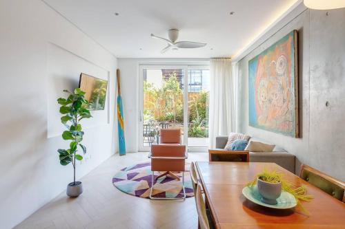 a living room with a table and a couch at 'The Fern' Split-Level Retreat with Lush Courtyard in Sydney