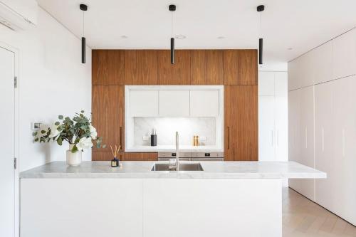 a kitchen with a white counter and a sink at Luxe Eco Suite in Australia's Greenest Building in Sydney