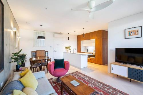 a living room with a couch and a table at 'The Fern' Light-Filled Urban Retreat near Dining in Sydney
