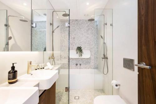 a bathroom with two sinks and a shower at 'Executive Luxury Retreat' Eco Passive Living in Sydney