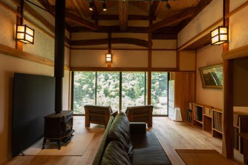 a living room with a couch and a fireplace at Ryokuinsansou-bettei - Vacation STAY 48641v in Yasugi