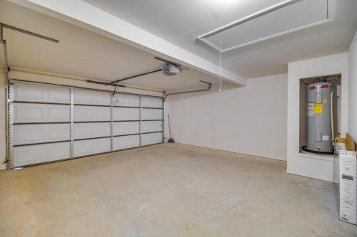 a garage with white garage doors and a fire hydrant at Charming Arkansas Getaway - Walk to Downtown! in Fort Smith