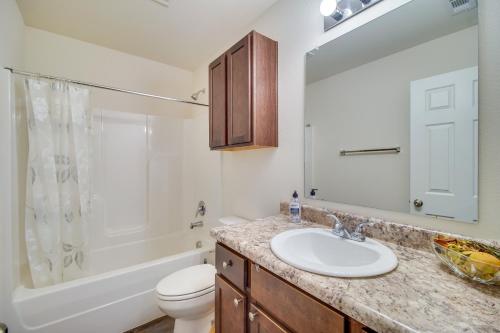 a bathroom with a sink and a toilet and a tub at Charming Arkansas Getaway - Walk to Downtown! in Fort Smith