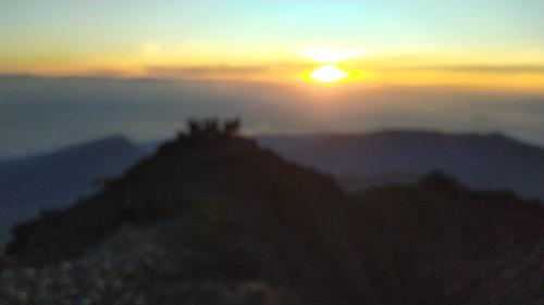 a view of the sun rising over a mountain at Rinjani in Bayan