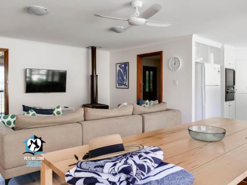 a living room with a couch and a table at In The Sand Dunes & Renovated House in Goolwa South